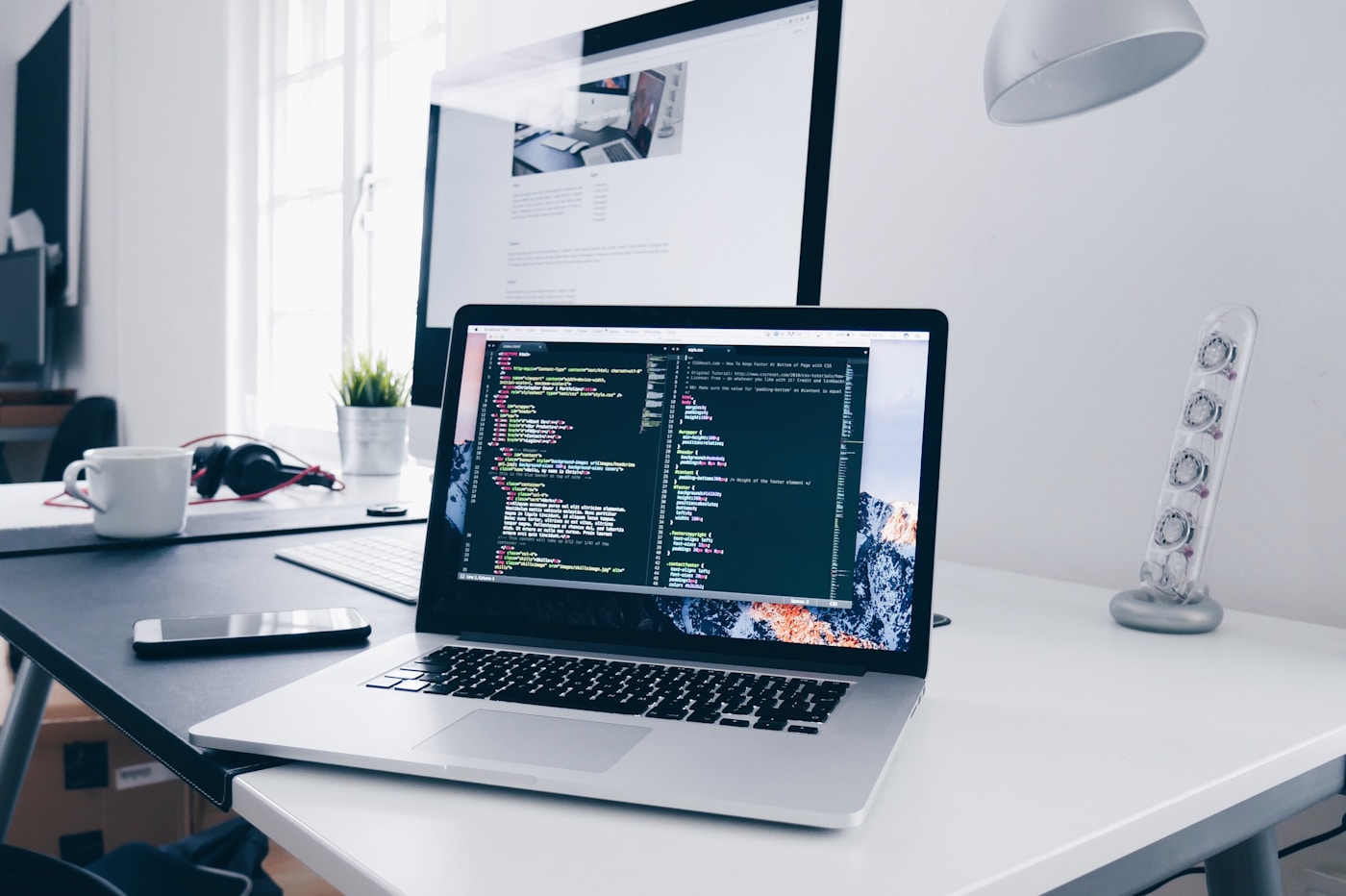 Web designer working on website layouts and interface designs on a laptop